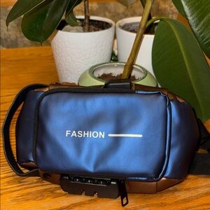 Blue and Bronze Lockable cross body bag with USB Port insert